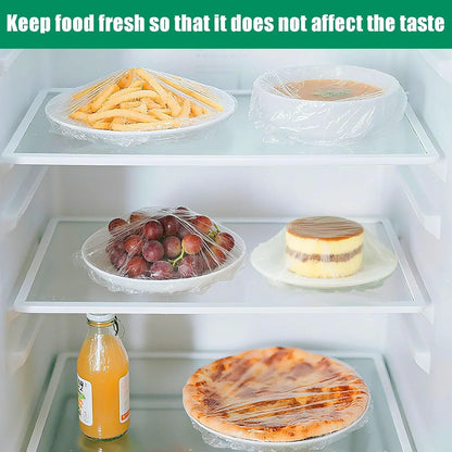 Refrigerator shelves with food covered in plastic wrap to keep items fresh and maintain taste