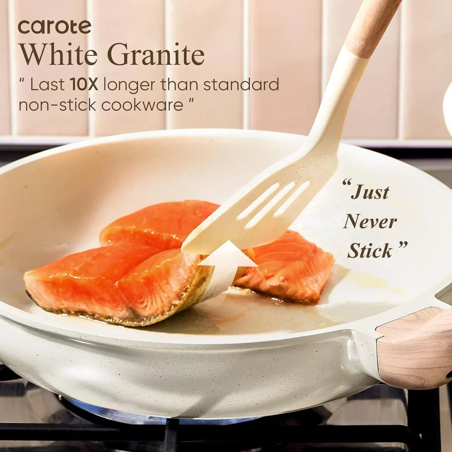 Nonstick white granite frying pan on stove cooking salmon fillets with spatula