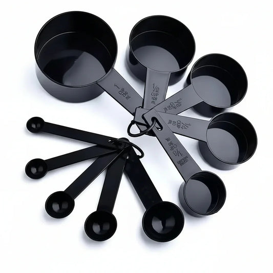 Black measuring cups and spoons set for baking and cooking, kitchen tools with metric and imperial markings
