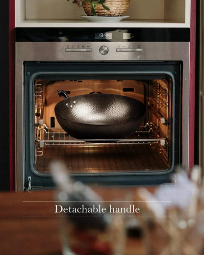 Wok with detachable handle inside oven, showcasing versatile kitchen cookware for everyday cooking.