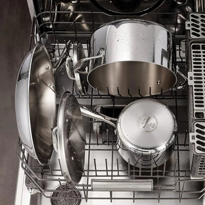Stainless steel cookware set in dishwasher, featuring pots, pans, and lids with water droplets, ideal for kitchen cleaning and storage.