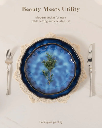 Blue ceramic plates with underglaze painting, lace placemat, and silverware for elegant table setting