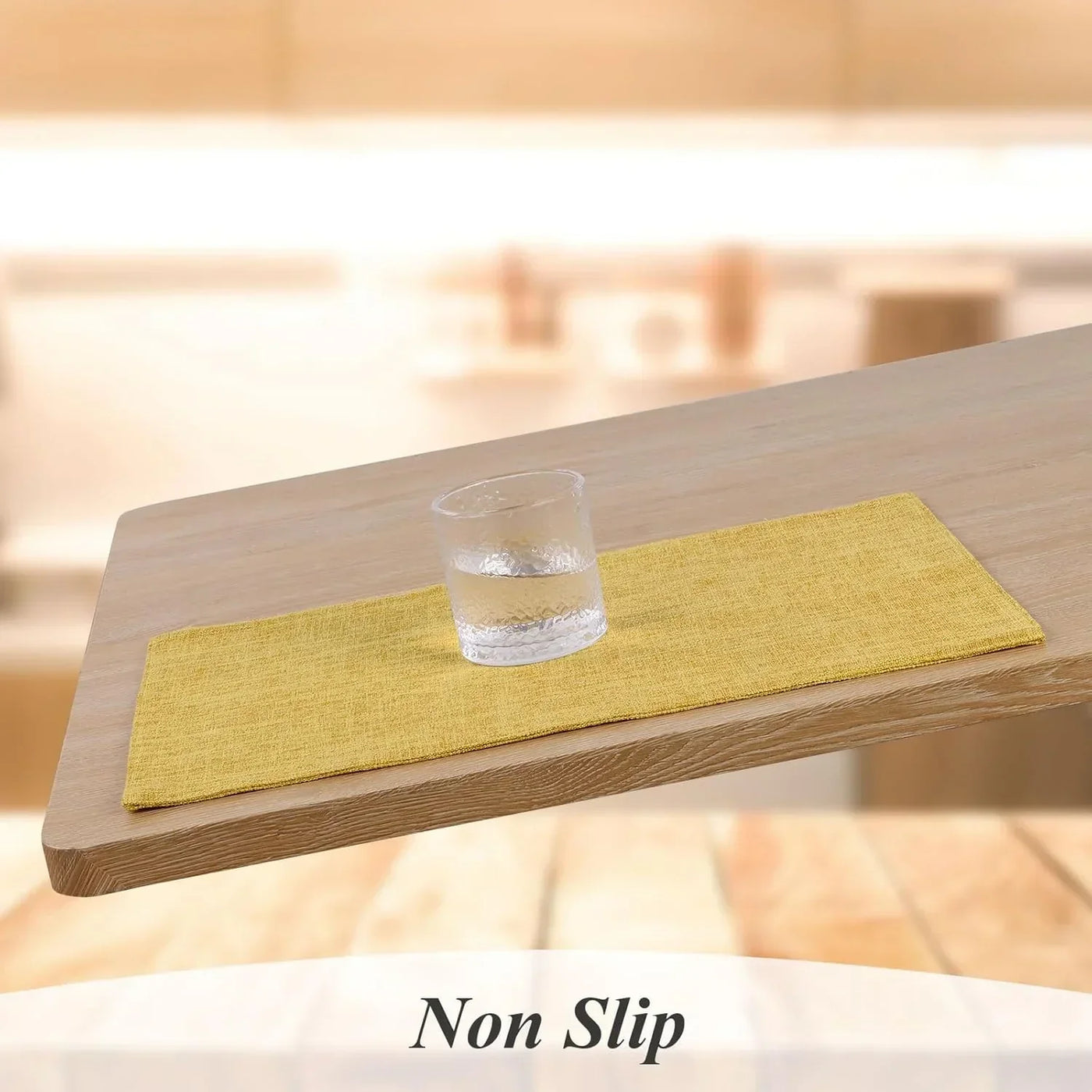 Yellow non-slip placemat on wooden table with glass, ideal for kitchen dining and table linens