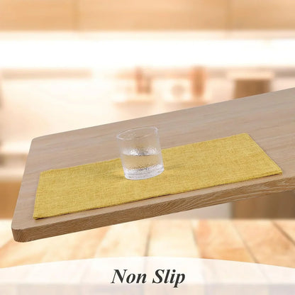 Yellow non-slip placemat on wooden table with glass, ideal for kitchen dining and table linens