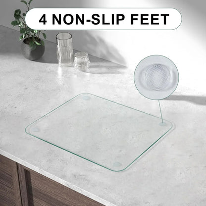 Clear glass kitchen trivet with 4 non-slip feet on countertop, ideal for hot pots and organized cooking