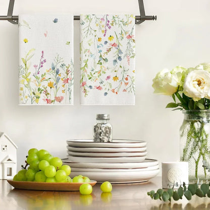 Floral kitchen towels hanging on rack with plates, grapes, and flowers for cozy cooking and serving