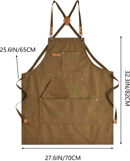 Brown canvas kitchen apron with cross-back straps, front pockets, and leather accents for cooking and baking