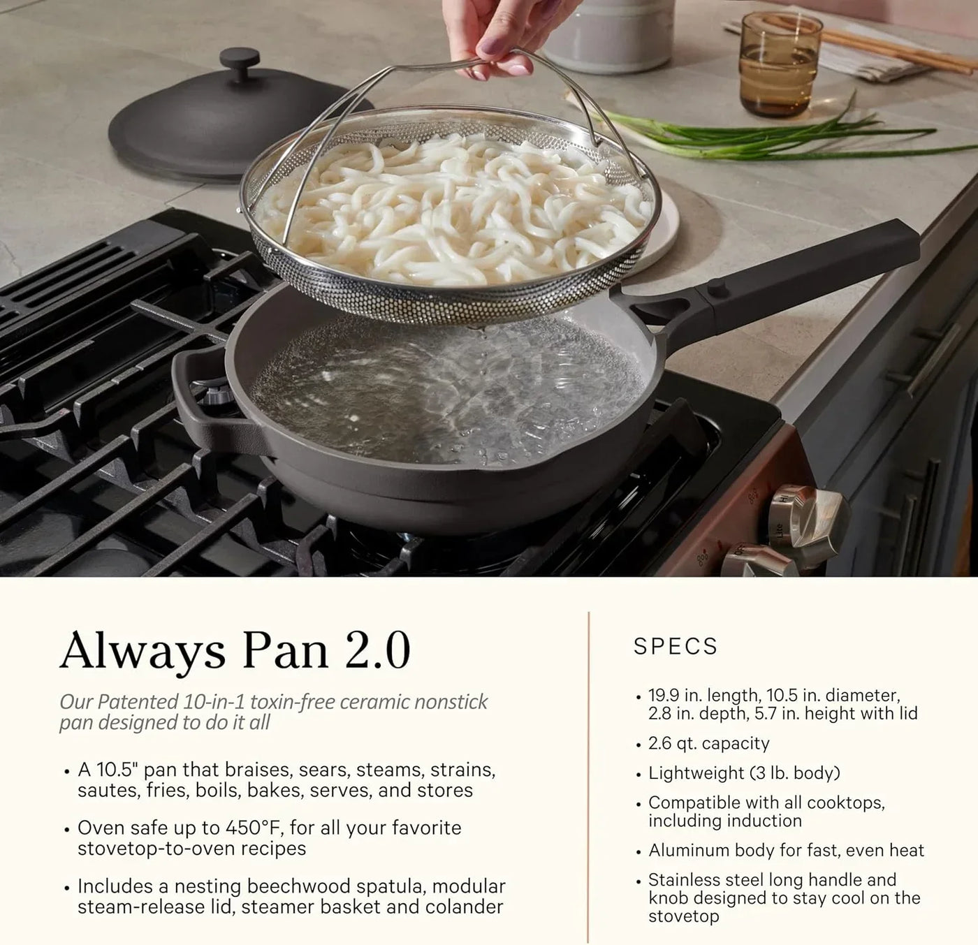 Nonstick cooking pan with steamer basket straining udon noodles on stovetop, kitchen cookware