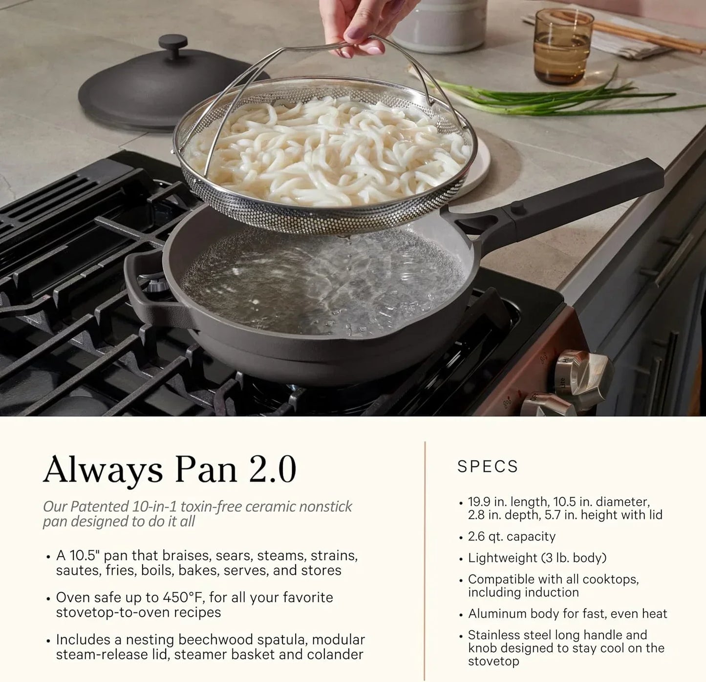 Nonstick cooking pan with steamer basket straining udon noodles on stovetop, kitchen cookware