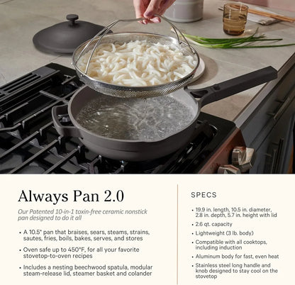 Nonstick cooking pan with steamer basket straining udon noodles on stovetop, kitchen cookware