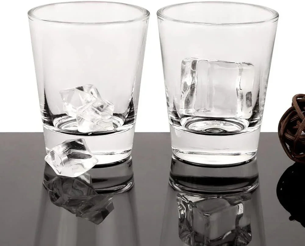 Clear glass tumblers with ice cubes on reflective surface, ideal for drinks and entertaining