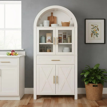 White kitchen storage cabinet with arched top, glass doors, and gold handles for organized cookware and pantry items
