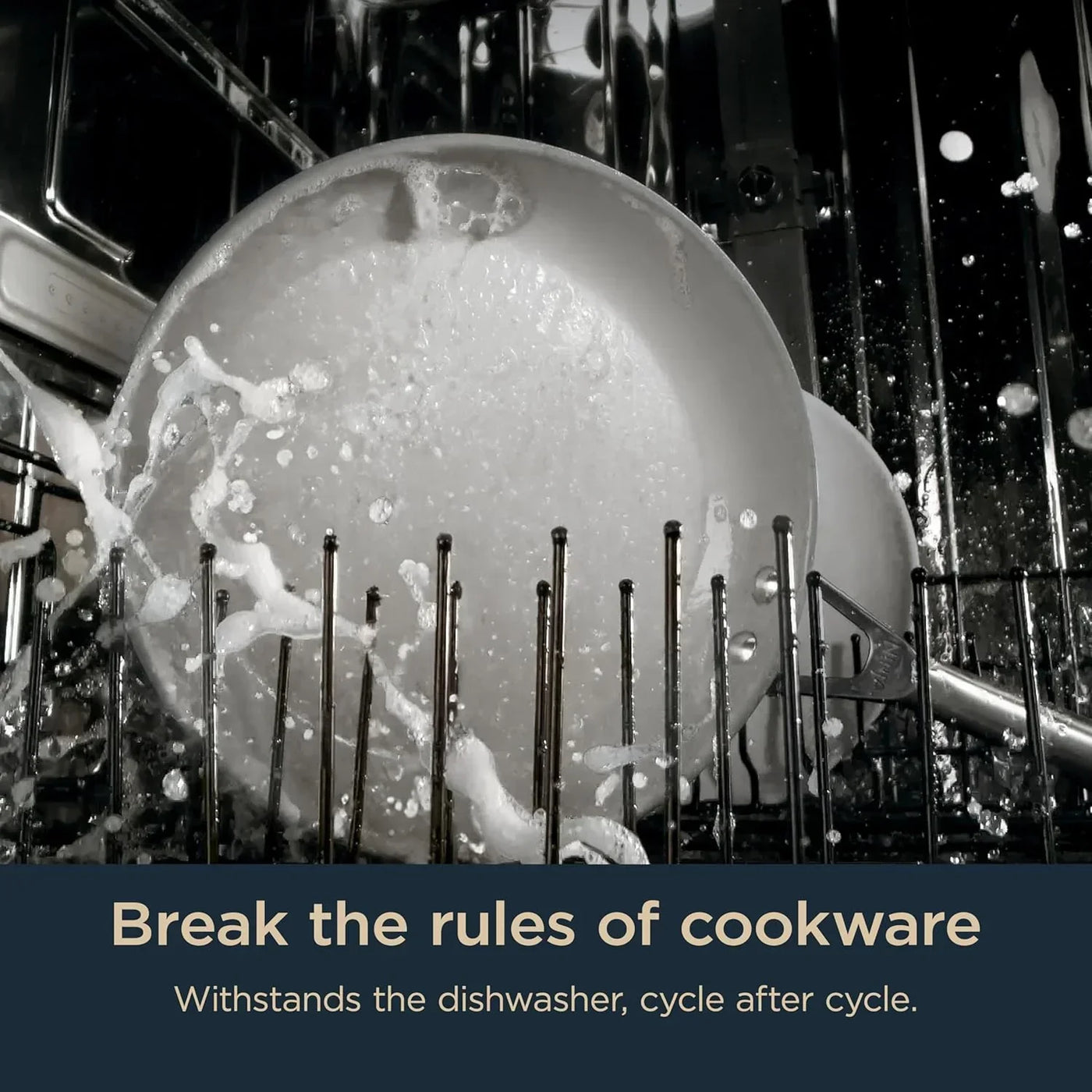 Dishwasher-safe cookware being cleaned with water spray inside dishwasher
