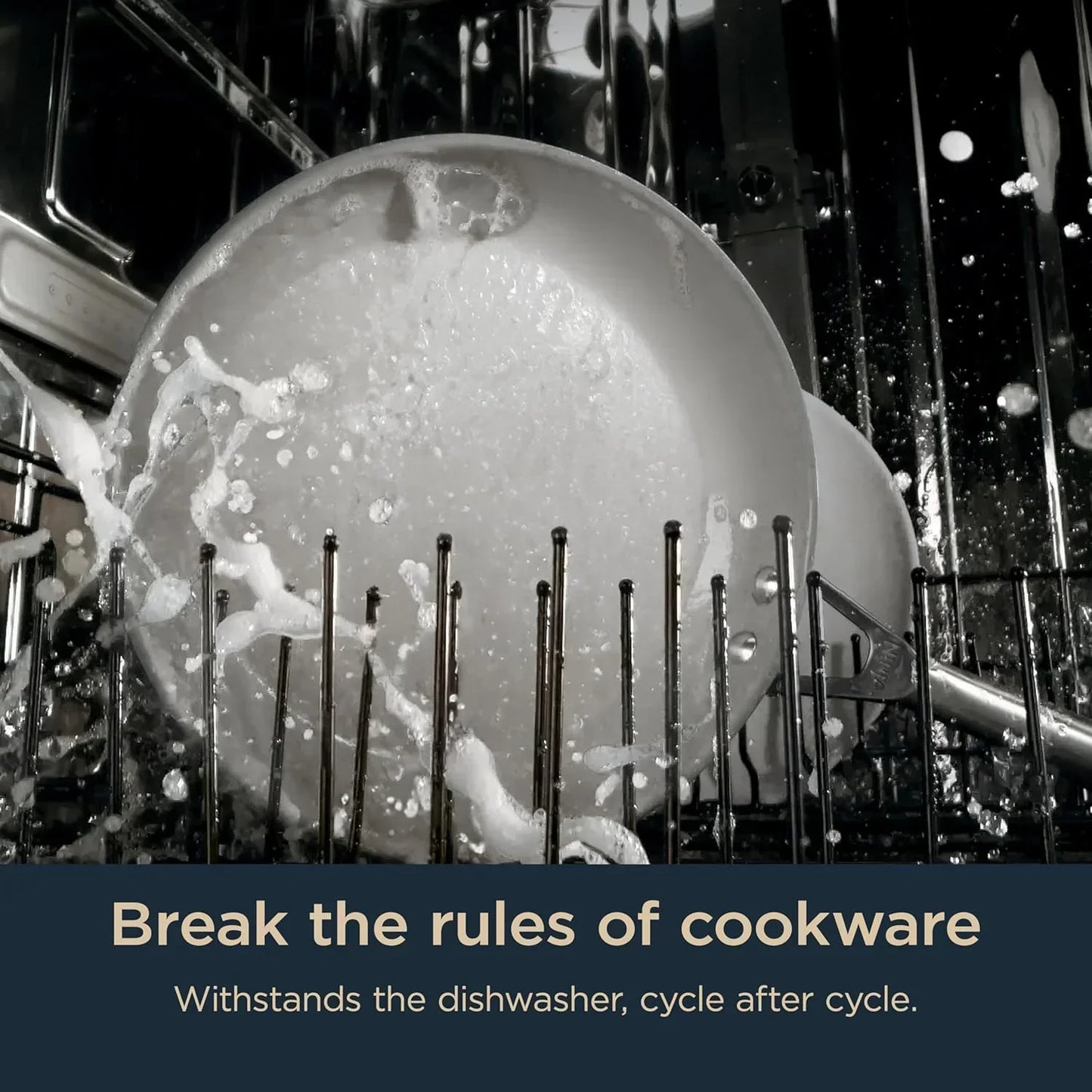 Dishwasher-safe cookware being cleaned with water spray inside dishwasher