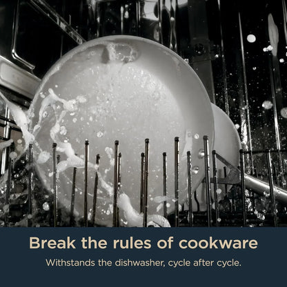 Dishwasher-safe cookware being cleaned with water spray inside dishwasher