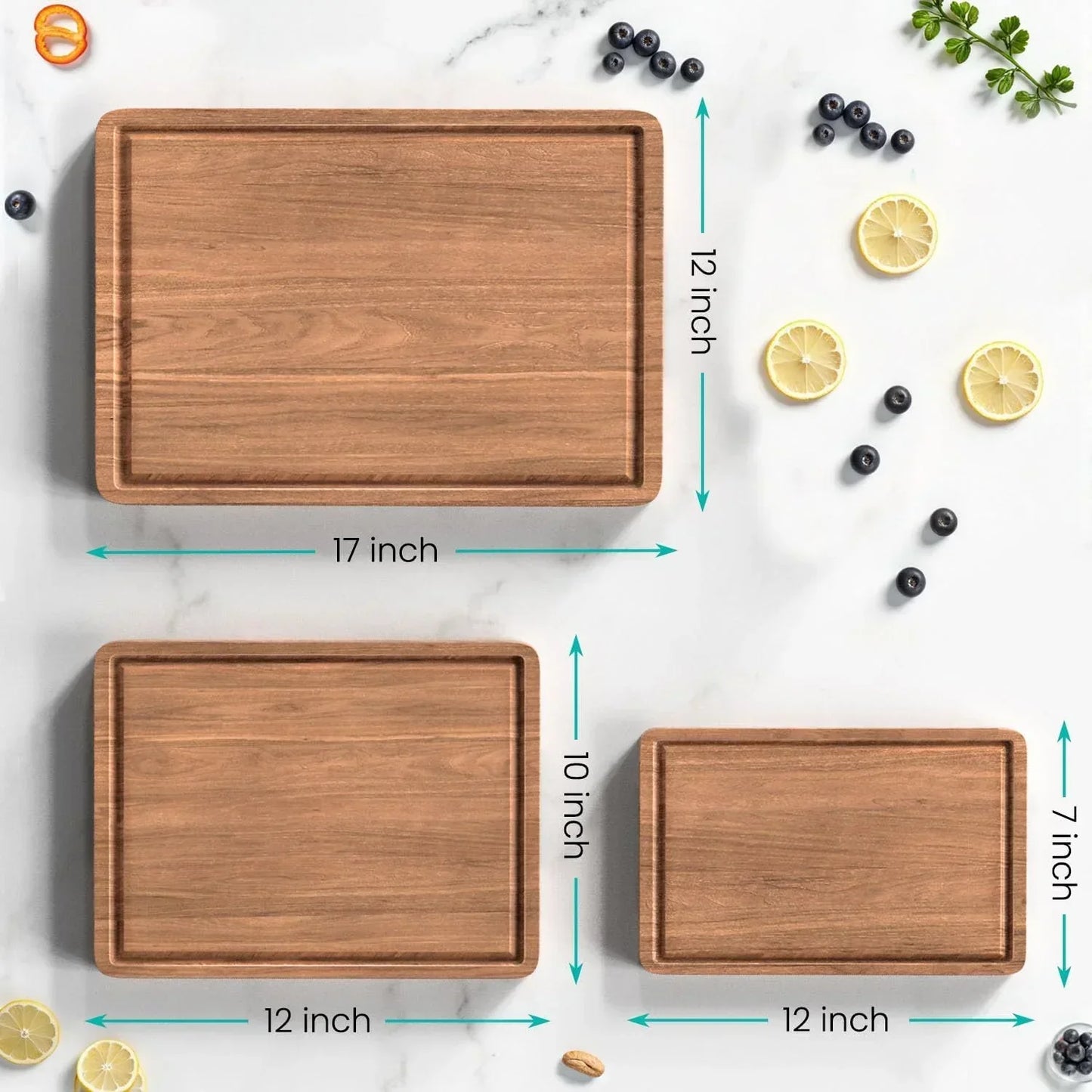 Wooden cutting boards in 17x12, 12x10, and 12x7 inch sizes on marble with lemon and blueberries