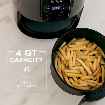 Ninja air fryer with 4 qt capacity cooking 2 lbs of golden french fries on marble countertop