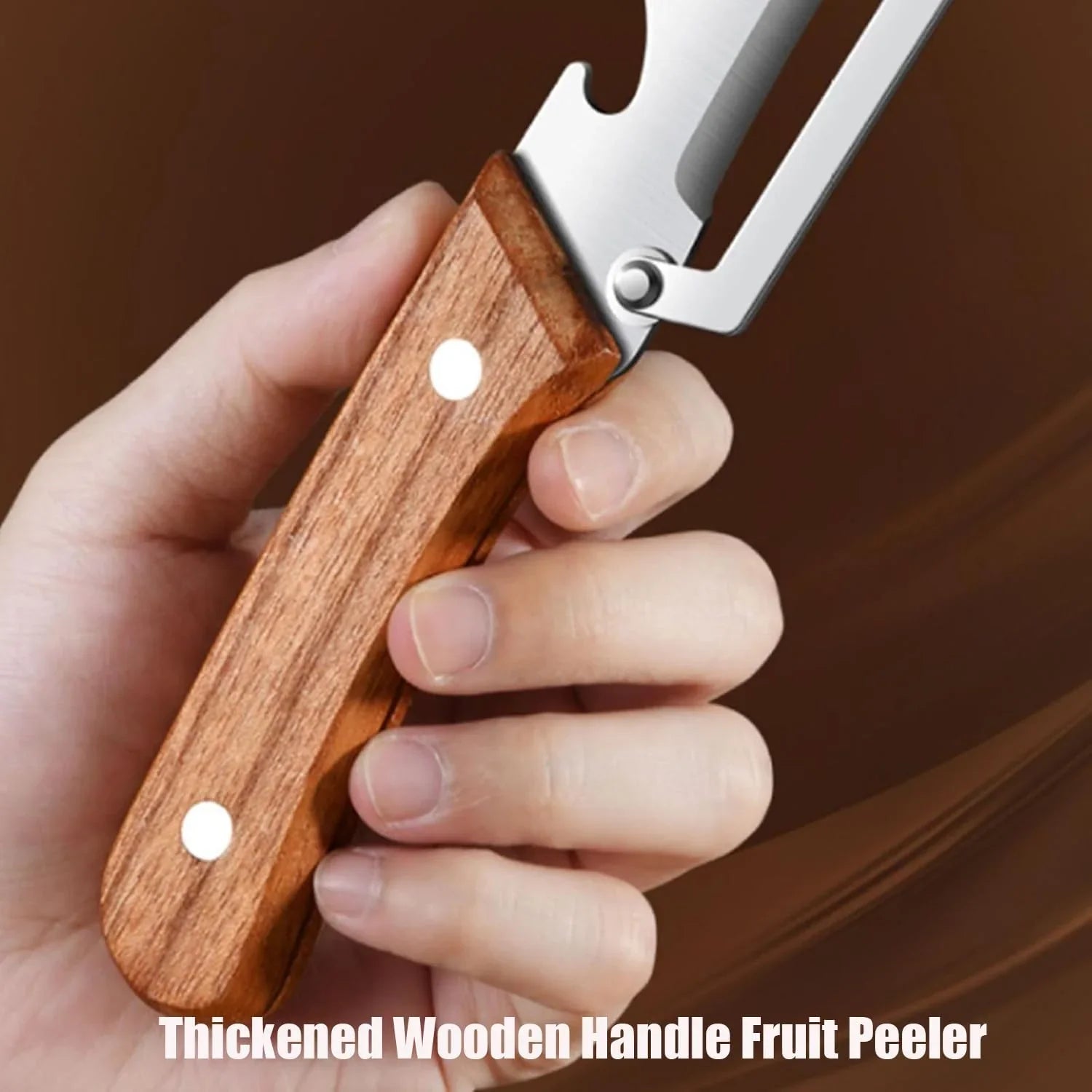 Hand holding a stainless steel fruit peeler with a thick wooden handle against a brown background.
